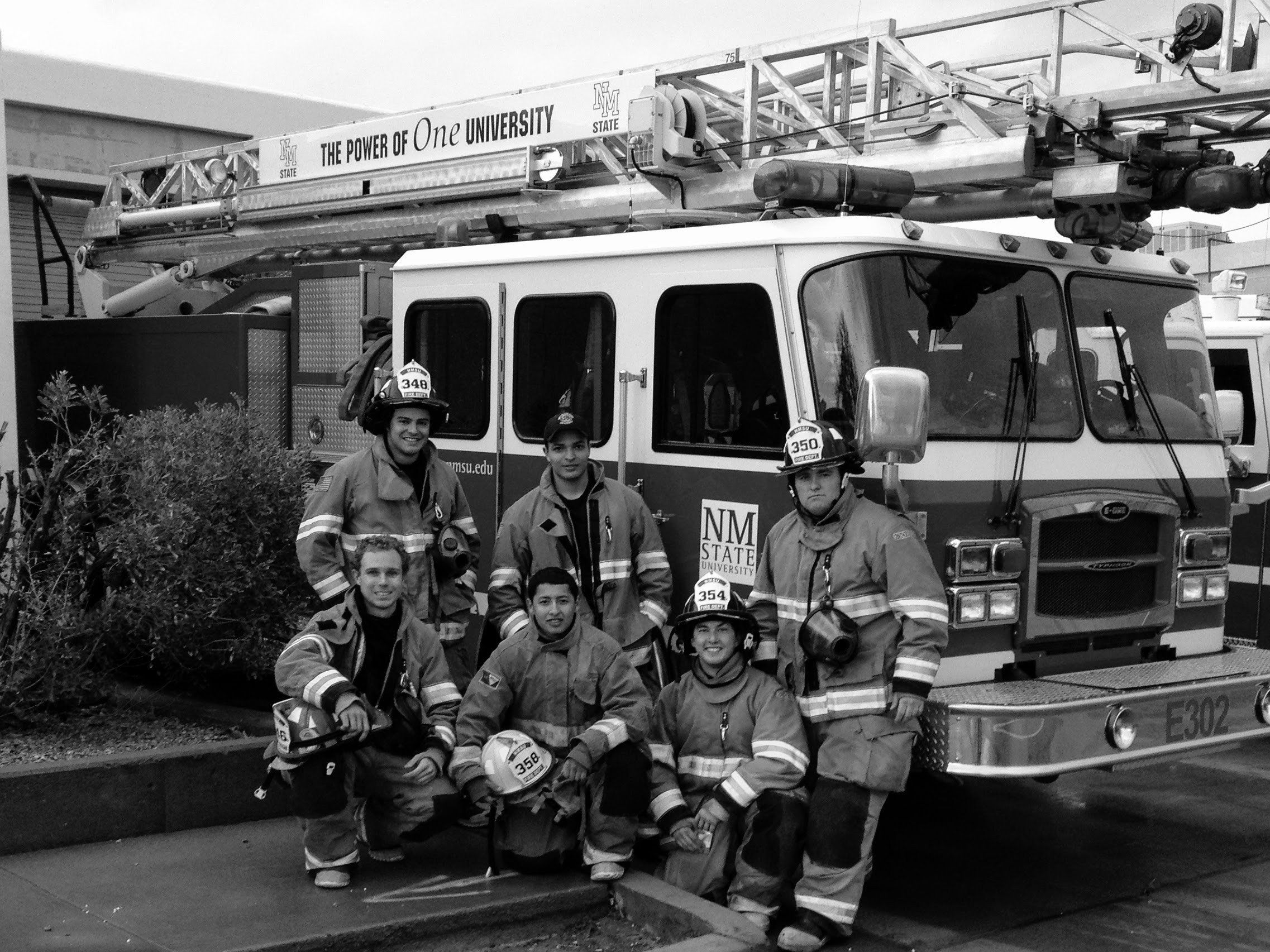 Dr. Oushy during his years as a student firefighter at New Mexico State University, with his crew beside an NMSU fire engine