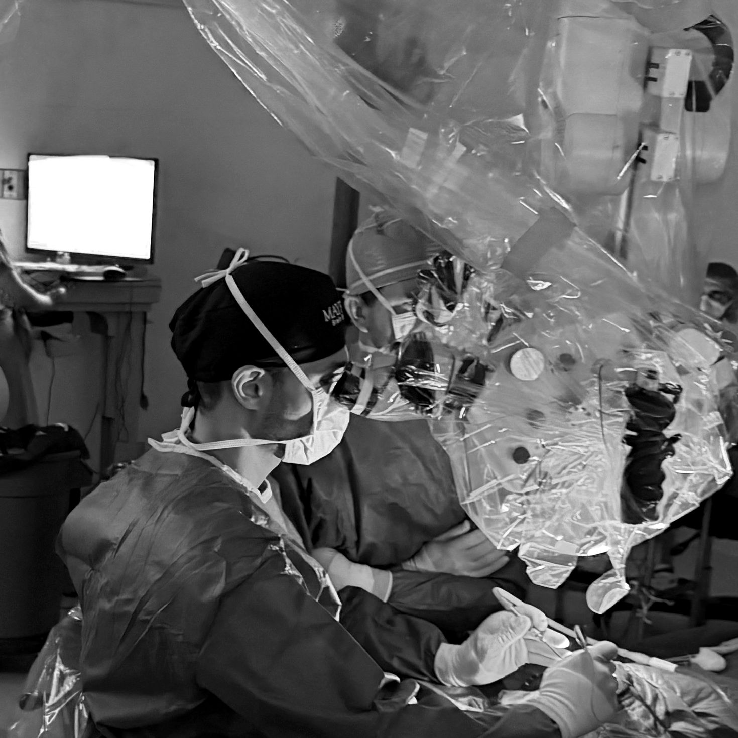Soliman Oushy, MD operating at the surgical microscope with a colleague at Mayfield Brain & Spine